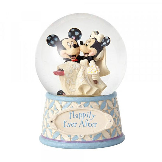 Disney Traditions Mickey carries Minnie in her wedding dress inside a waterball with a plaque which says 'Happily Ever After' on it figurine