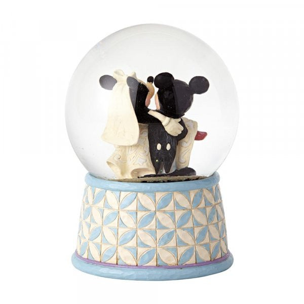 Disney Traditions Mickey carries Minnie in her wedding dress inside a waterball with a plaque which says 'Happily Ever After' on it figurine