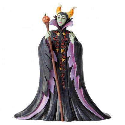 Disney Traditions Maleficent Dressed in a magnificent Halloween dress and cape complete with candy corn horns and a pumpkin staff figurine