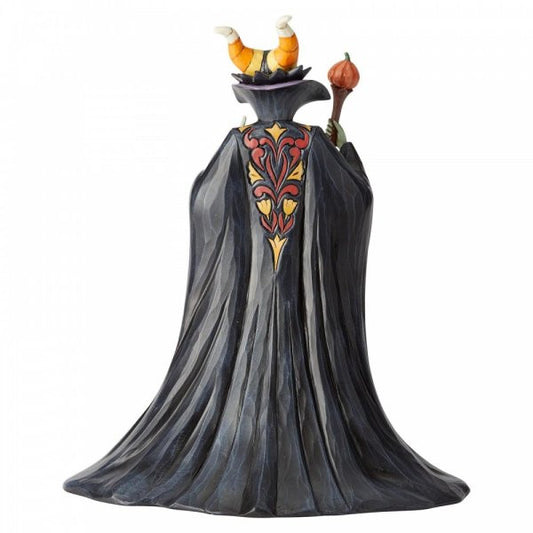 Disney Traditions Maleficent Dressed in a magnificent Halloween dress and cape complete with candy corn horns and a pumpkin staff figurine