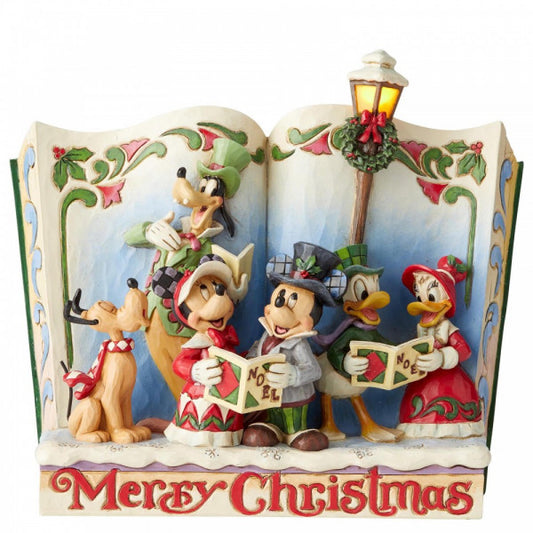 Disney Traditions Mickey and friends joyfully celebrate the season by carolling throughout the town in a storybook figurine