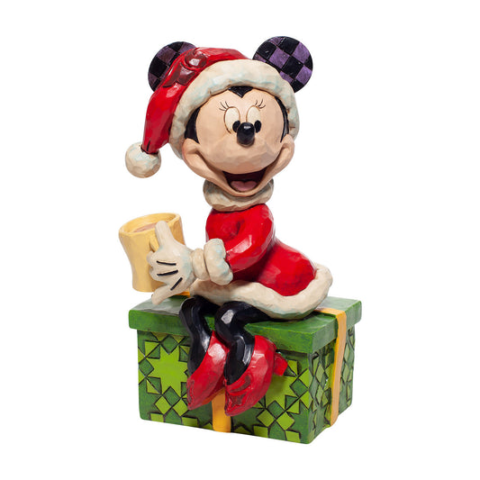 Disney Traditions Minnie Mouse sits on a present sipping hot chocolate figurine