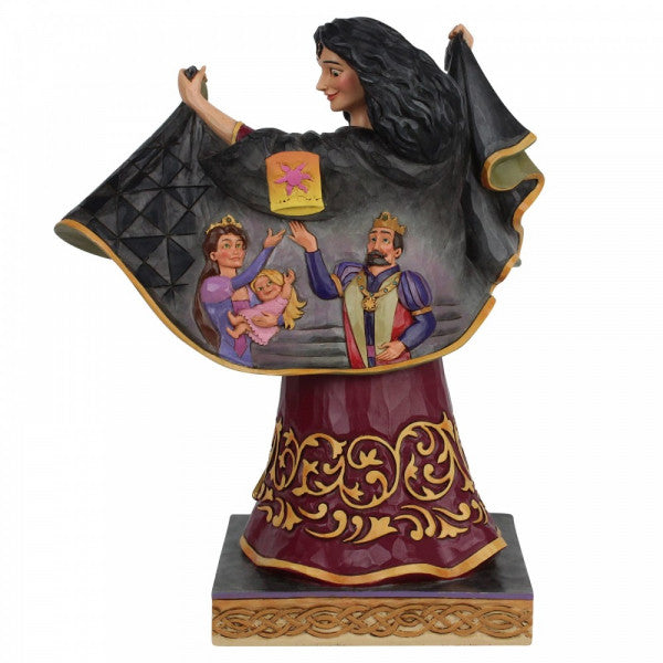 Disney Traditions Mother Gothel flaps her cloak to reveal a tender moment shared between Rapunzel and her parents figurine