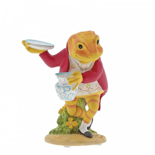 The Beatrix Potter Mr. Jeremy Fisher in the Larder Figurine features him in a red coat, yellow-striped trousers, and white shirt, holding a blue-and-white jug and plate on a grassy base—an enchanting collectable.