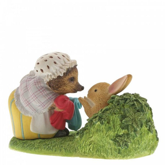 The Beatrix Potter Mrs. Tiggy-Winkle Returning Peters Laundered Jacket figurine features the bonneted hedgehog with a blue jacket and rabbit—a charming collectible and perfect adult gift for storybook lovers.