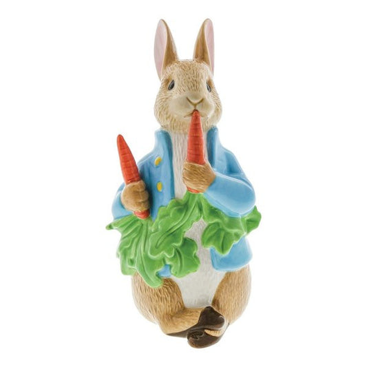 The Beatrix Potter Peter Rabbit with Radishes Porcelain Figurine - Limited Edition features the beloved character in a blue jacket holding red radishes and green leaves—an ideal collectible for any Beatrix Potter fan.