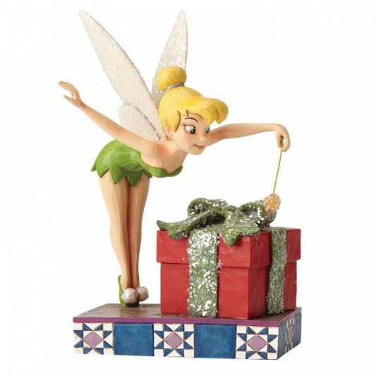 Disney Traditions Tinker Bell from Peter Pan waves her wand over the Christmas Present figurine