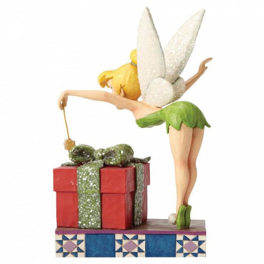 Disney Traditions Tinker Bell from Peter Pan waves her wand over the Christmas Present figurine
