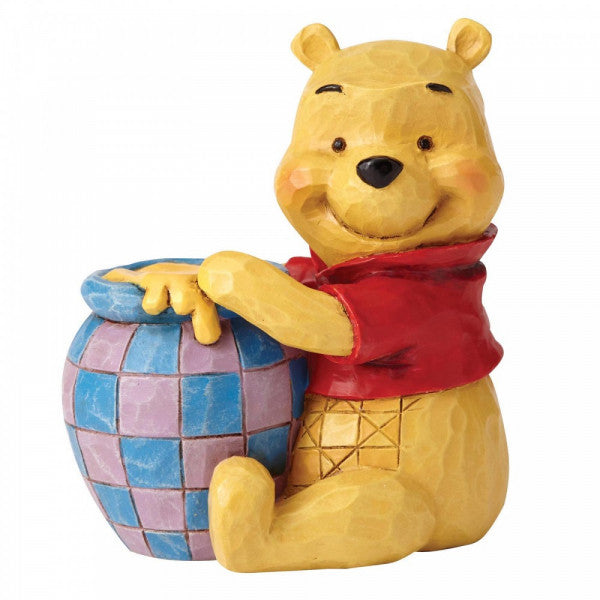 Disney Traditions Winnie the pooh sitting with his 'hunny' pot mini figurine