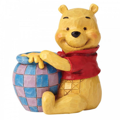Disney Traditions Winnie the pooh sitting with his 'hunny' pot mini figurine