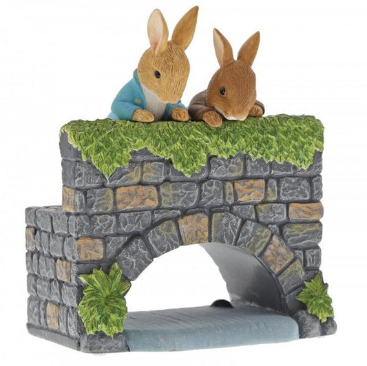 The Beatrix Potter Peter & Benjamin Bunny on the Bridge Figurine features two rabbits in a charming scene, making it a delightful collectable gift for fans of Peter Rabbit.