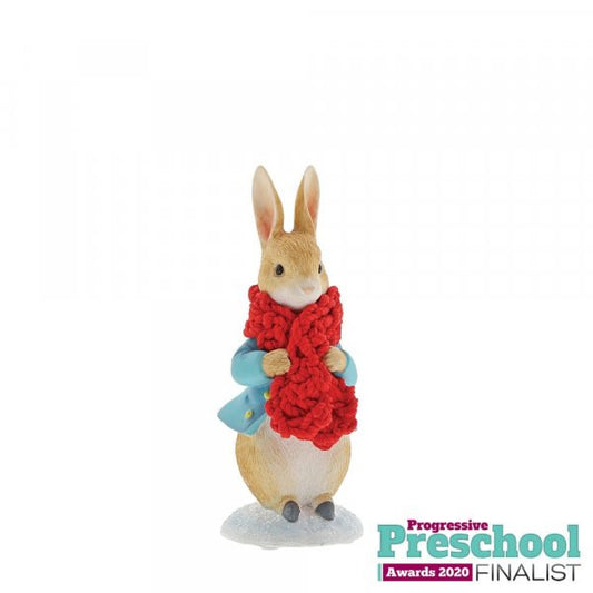 The Beatrix Potter Peter Rabbit in a Festive Scarf Figurine stands upright in a blue jacket with a festive scarf, shown alongside a Progressive Preschool Awards 2020 Finalist badge.