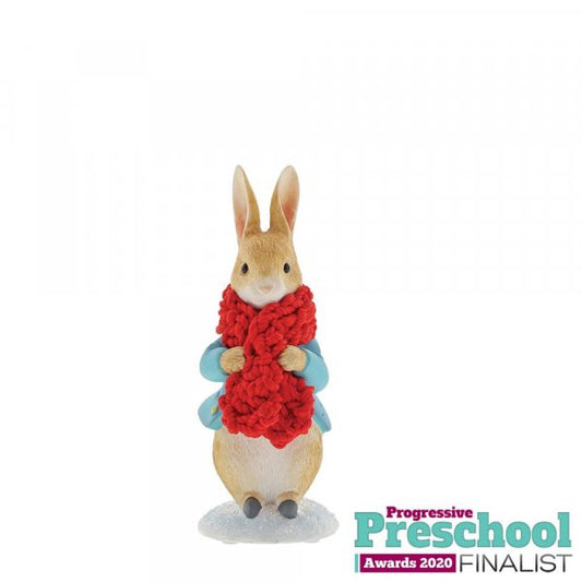The Beatrix Potter Peter Rabbit in a Festive Scarf Figurine features Peter in a blue coat and festive scarf on snow, with the Progressive Preschool Awards 2020 Finalist logo shown at the bottom right.