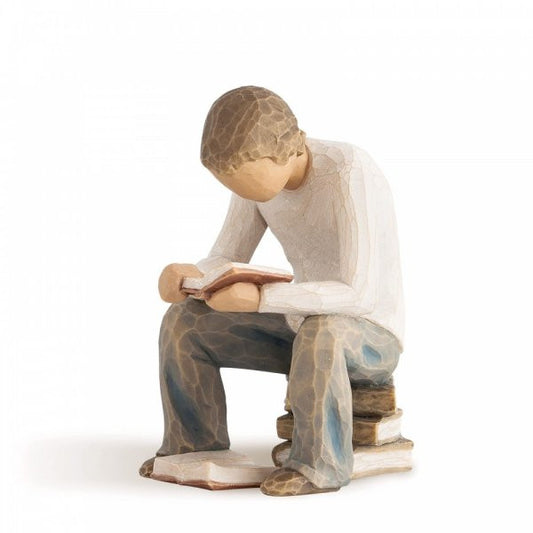 Willow Tree Figurine of a boy reading a book whilst sitting on a pile of books