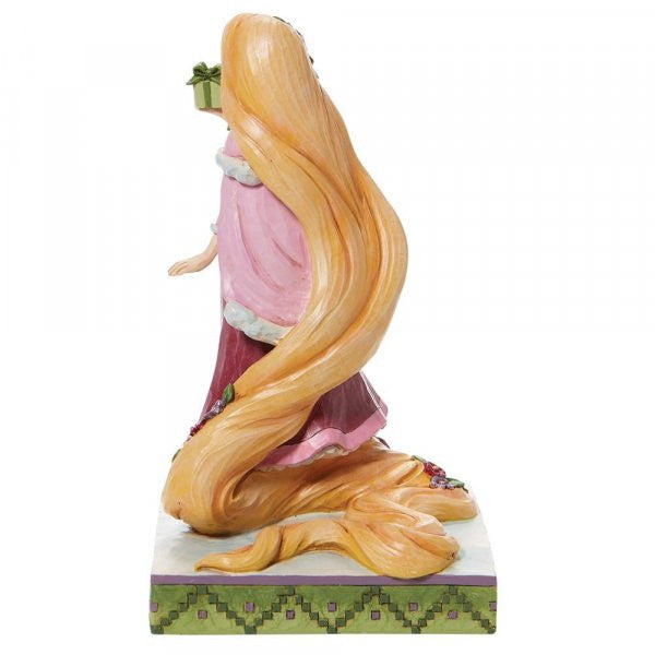 Disney Traditions Rapunzel from Tangled holding a present figurine