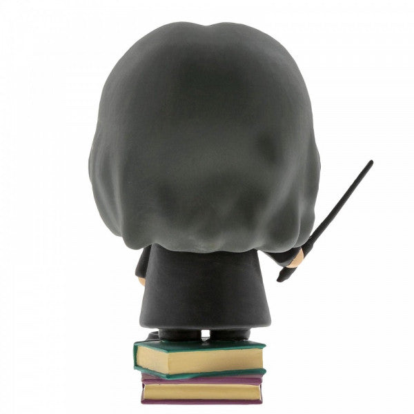 The Enesco Harry Potter Snape Figurine features Chibi Snape in a dark robe, standing on three colorful books and holding a wand—an ideal collectible for any Slytherin fan.