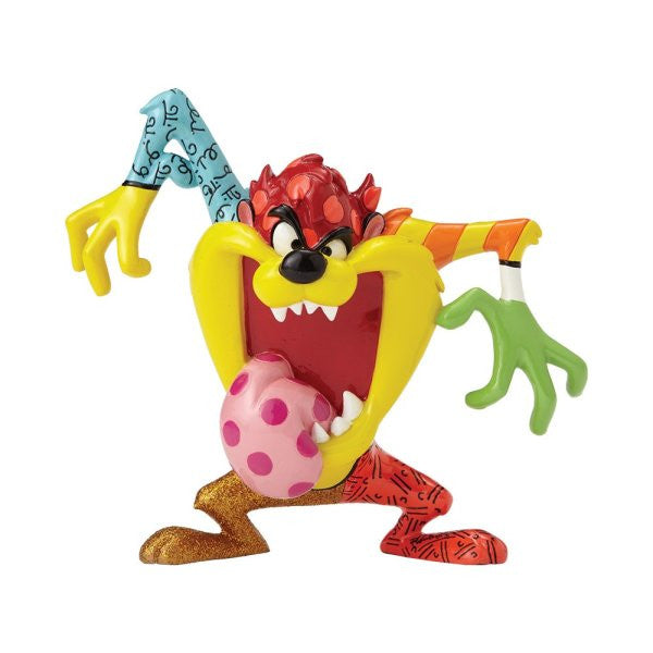 The Enesco Looney Tunes Britto Tasmanian Devil Figurine features a hand-painted, colorful design with an open mouth, pink polka-dot tongue, and bold mismatched patterns in red, green, yellow, and blue.