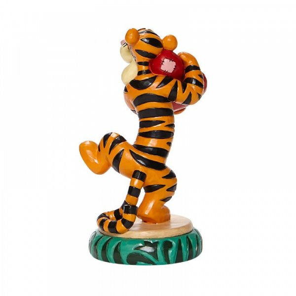 Disney traditions Tigger from Winnie the Pooh hugs a heart figurine