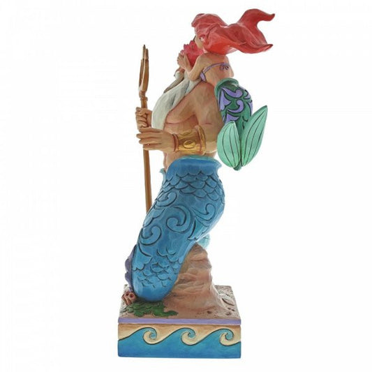 Disney traditions Ariel (The Little Mermaid) places a flower in father Triton's hair. Triton stands on his tail with gold trident in hand figurine