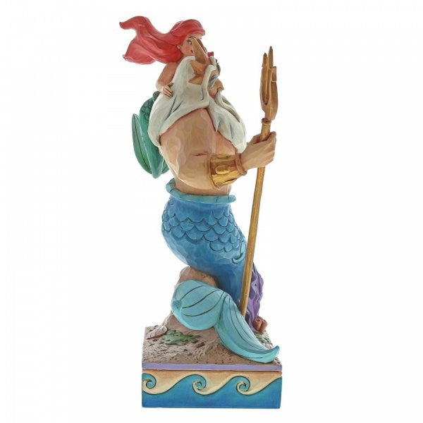 Disney traditions Ariel (The Little Mermaid) places a flower in father Triton's hair. Triton stands on his tail with gold trident in hand figurine