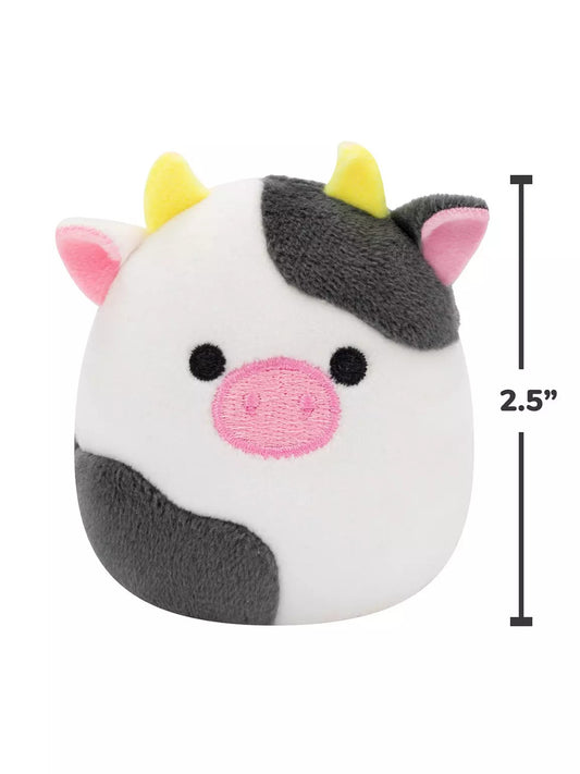 The Squishmallows 6 Pack of Micromallows includes cow-shaped Connor, featuring black and white fur, a pink nose and ears, and yellow horns. Each plush collectible stands 2.5 inches tall, as shown by the measurement line beside it.