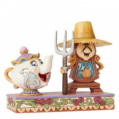 Disney Traditions Cogsworth and Mrs. Potts from Beauty and the Beast create a playful interpretation of a classic painting figurine