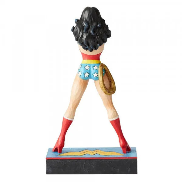 The DC Wonder Woman Amazonian Princess Silver Age Figurine by Jim Shore features Wonder Woman in classic DC Comics style, standing hands on hips with red top, blue star shorts, red boots, and golden lasso on a decorative base.