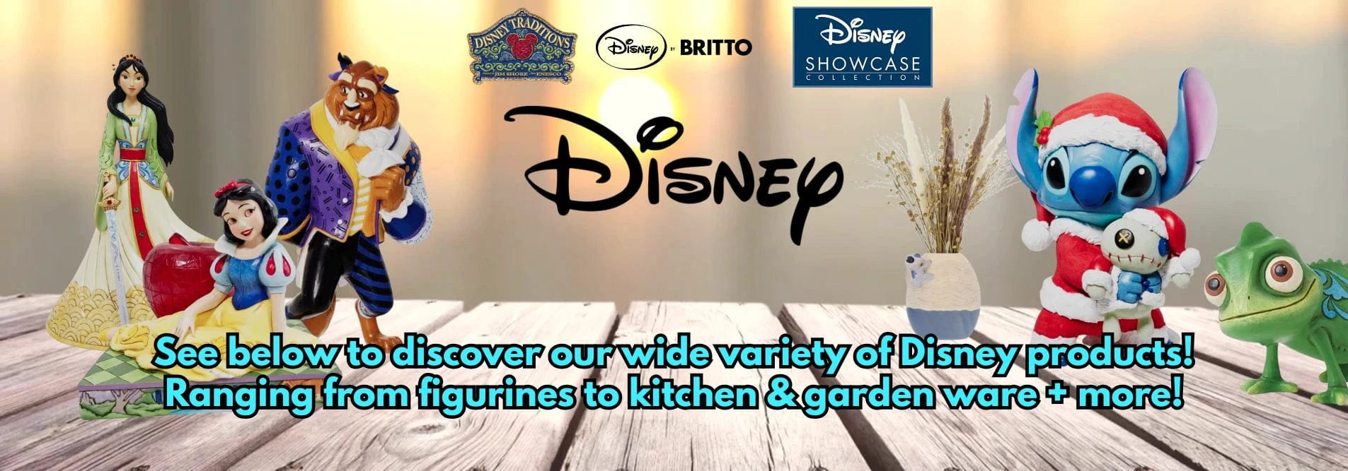 Disney figurines including Snow White, the Beast, and Stitch on a wooden surface with Disney and Britto branding.