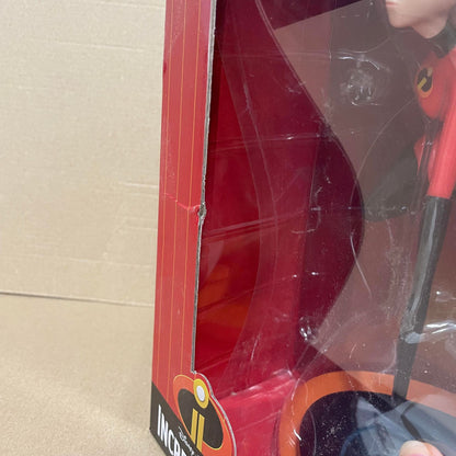 A Mrs Incredible Vinyl Figurine by Grand Jester Studios from Disney, in red packaging with a dent on the left side of the box. DAMAGED BOX noted. Incredibles logo at the bottom.
