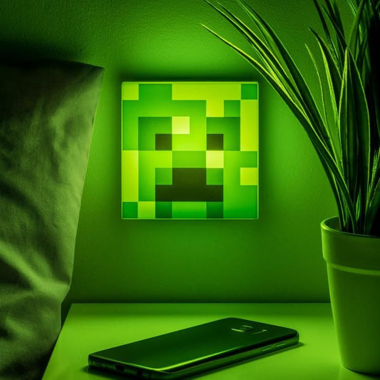 Add charm to your space with the Minecraft Creeper Night Light by Paladone—a glowing green accent from Paladone, perfect beside a potted plant and smartphone on your white bedside table.