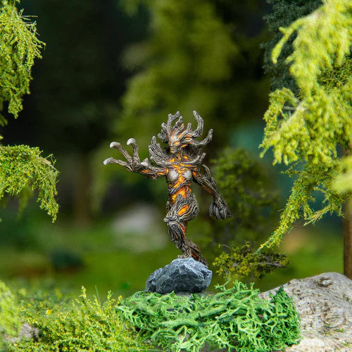 The Elder Scrolls Call To Arms Spriggan Matriarch by Modiphius is a miniature depicting a tree-like creature standing on a rock among lush green foliage, evoking an enchanted forest scene.